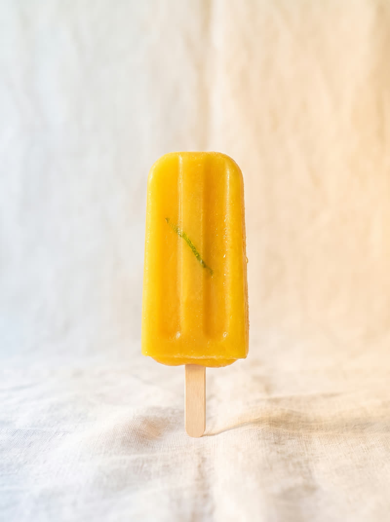 The Mango Lime pop, golden yellow, on cream linen