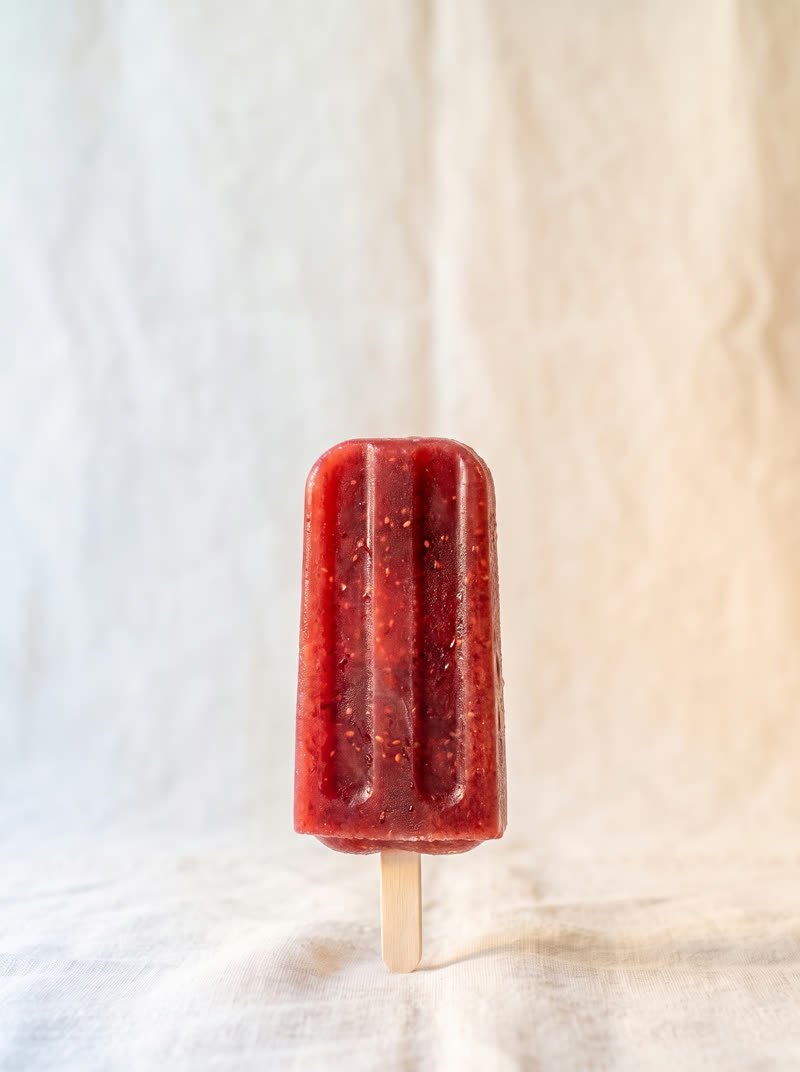 The Strawberry pop, deep red with real seeds, on cream linen